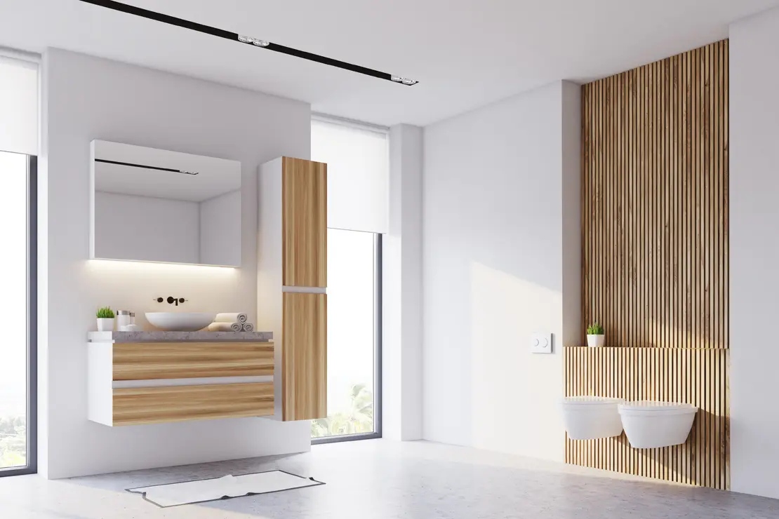 Baño con piso de microcemento gris y componentes de madera. Baño con piso de microcemento gris y componentes de madera.