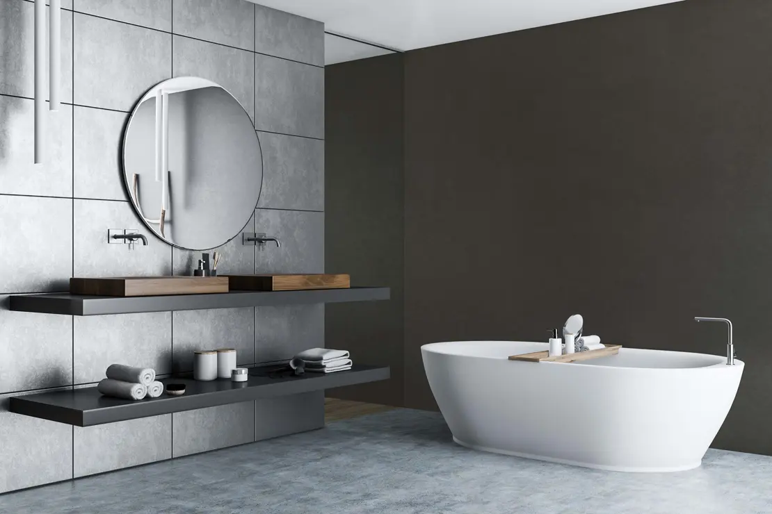 Aseo con muros de microcemento de tono gris profundo. Aseo con muros de microcemento de tono gris profundo.